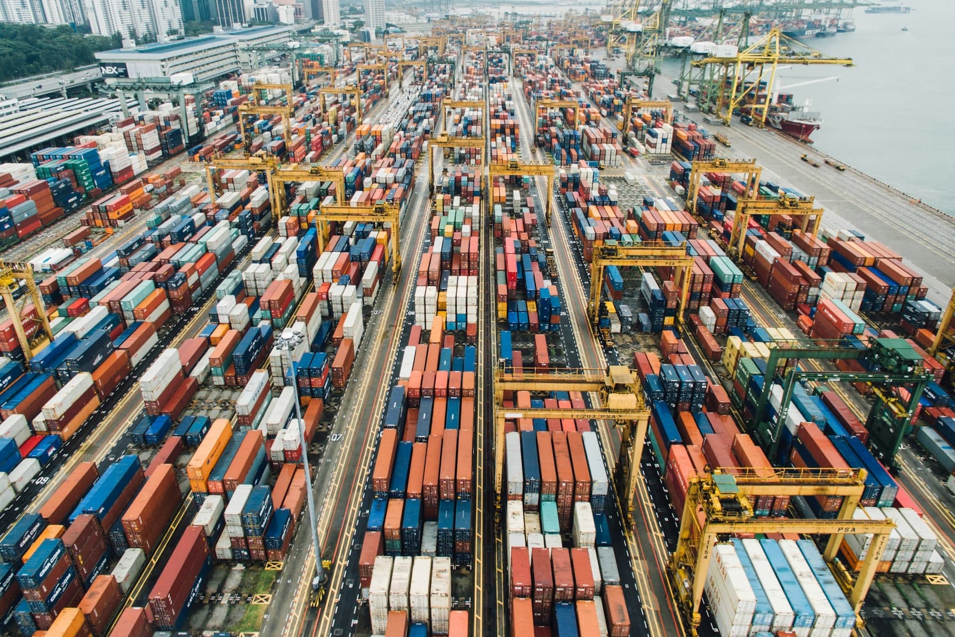 Aerial view of shipping containers and gantry cranes at an international cargo terminal