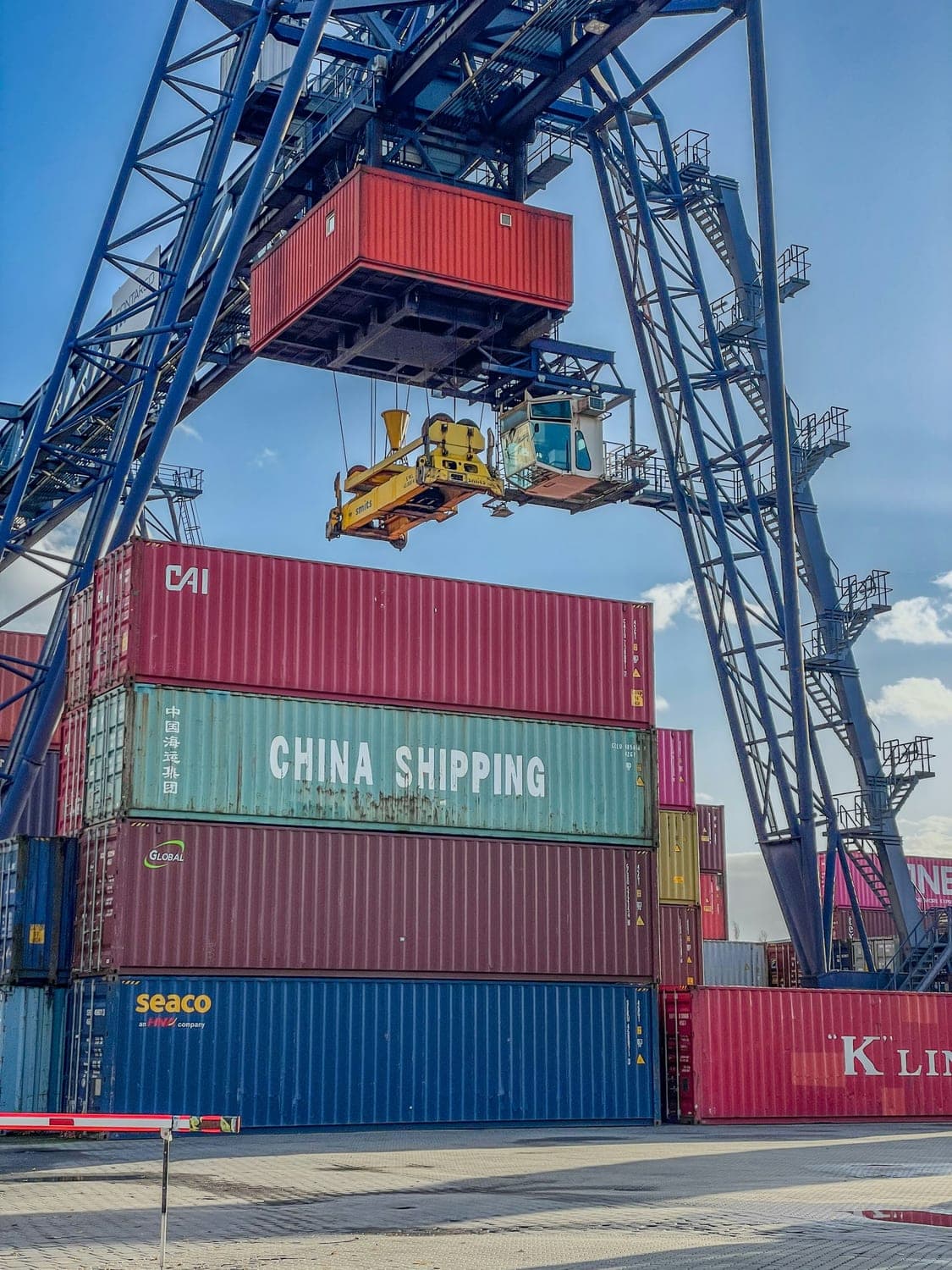 Gantry crane lifting a shipping container at a freight terminal