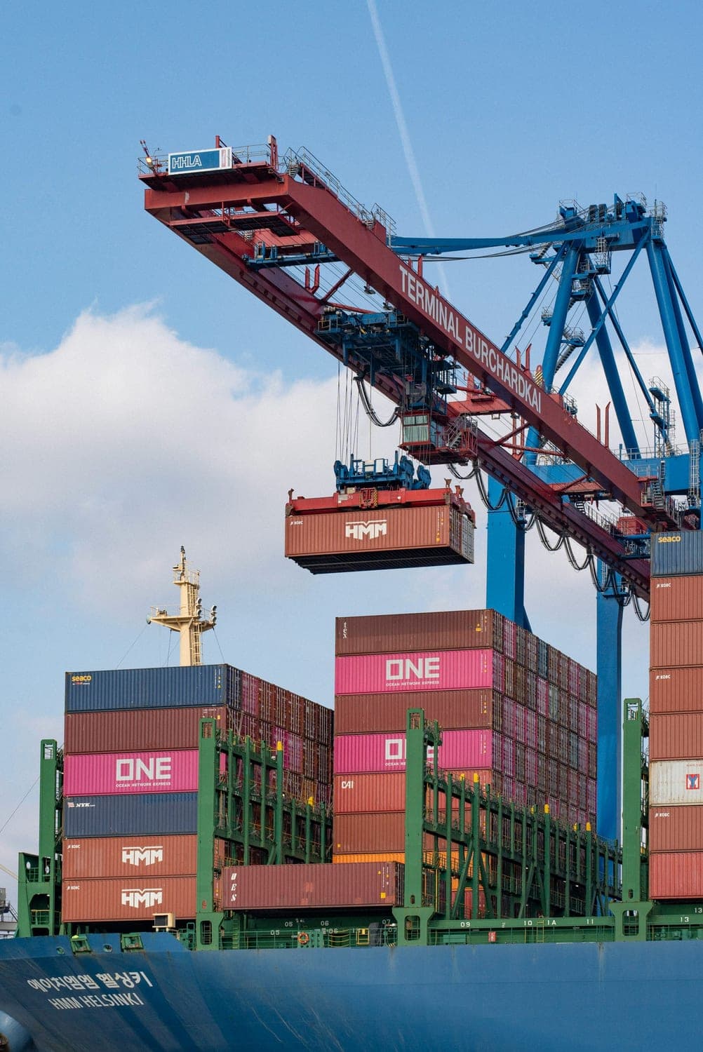 Gantry crane loading a container onto a vessel at a terminal