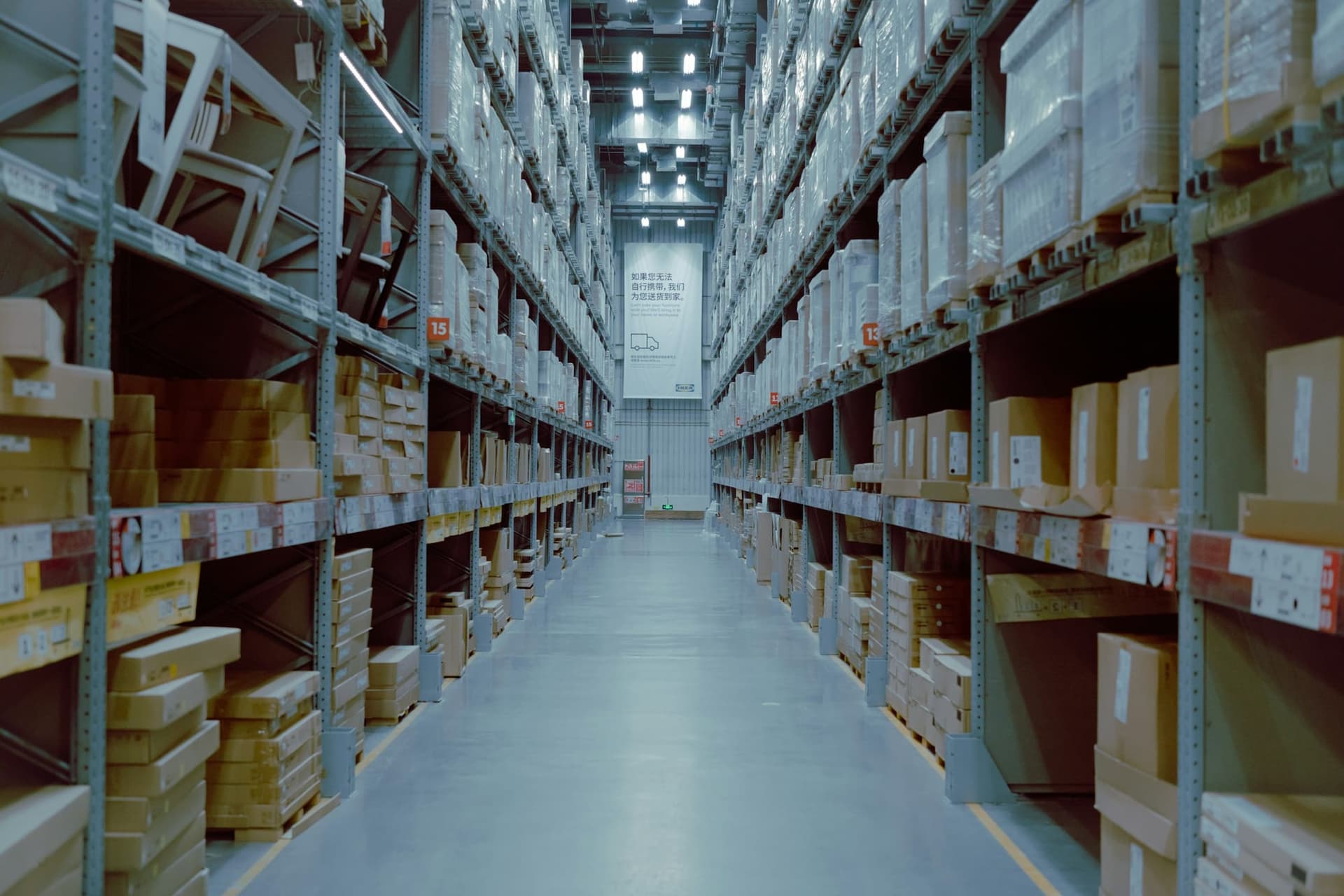 Cartons stacked on racking along an aisle in a distribution warehouse